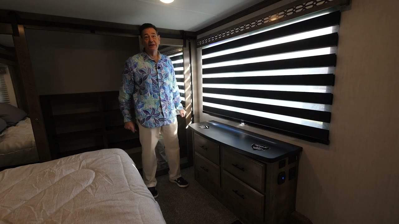 A man giving an RV Tour inside a Toy Hauler, the 2022 Forest River.