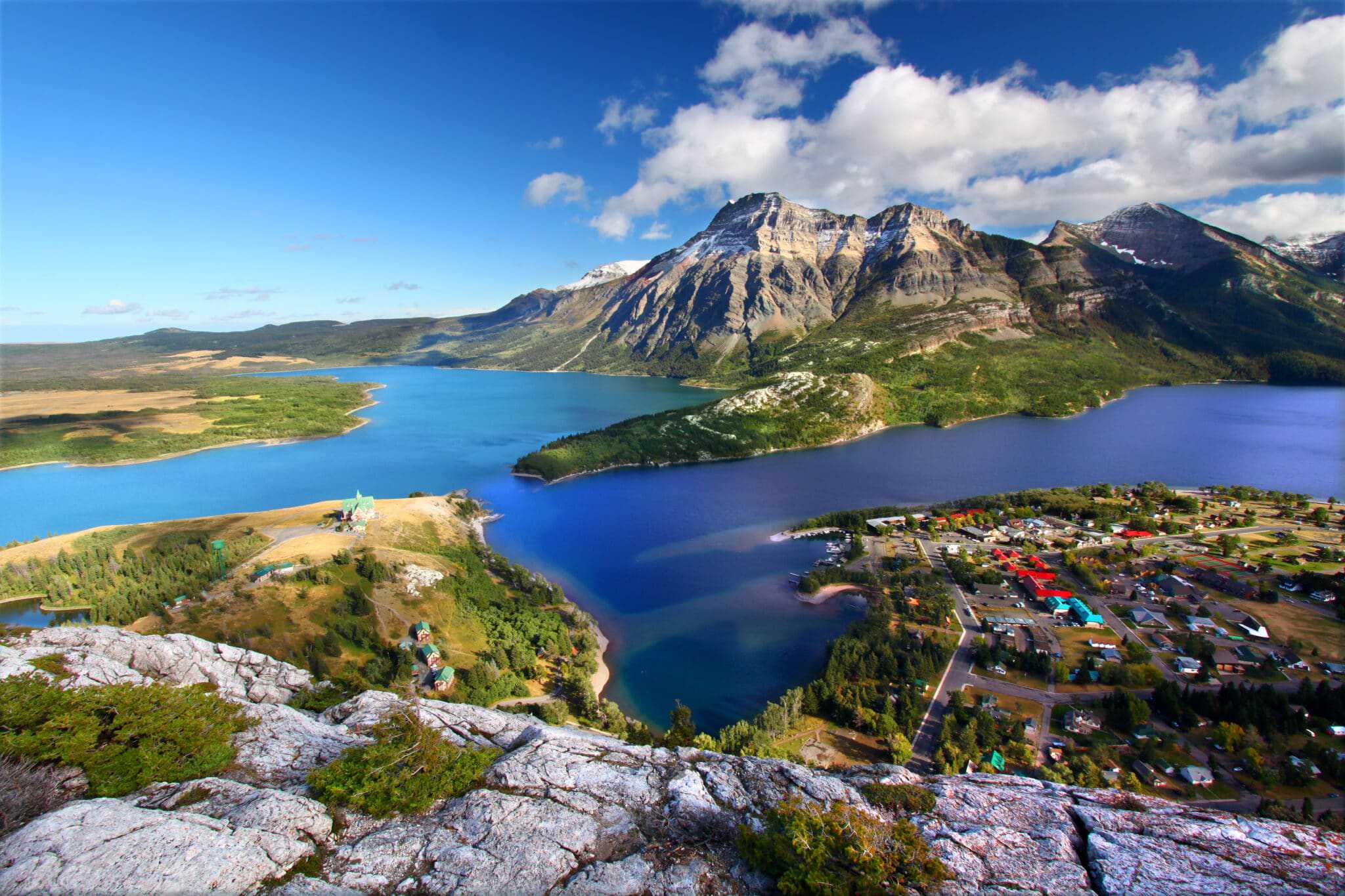 An aerial view of Waterton Lakes National Park, showcasing the visitor center and picturesque mountains.