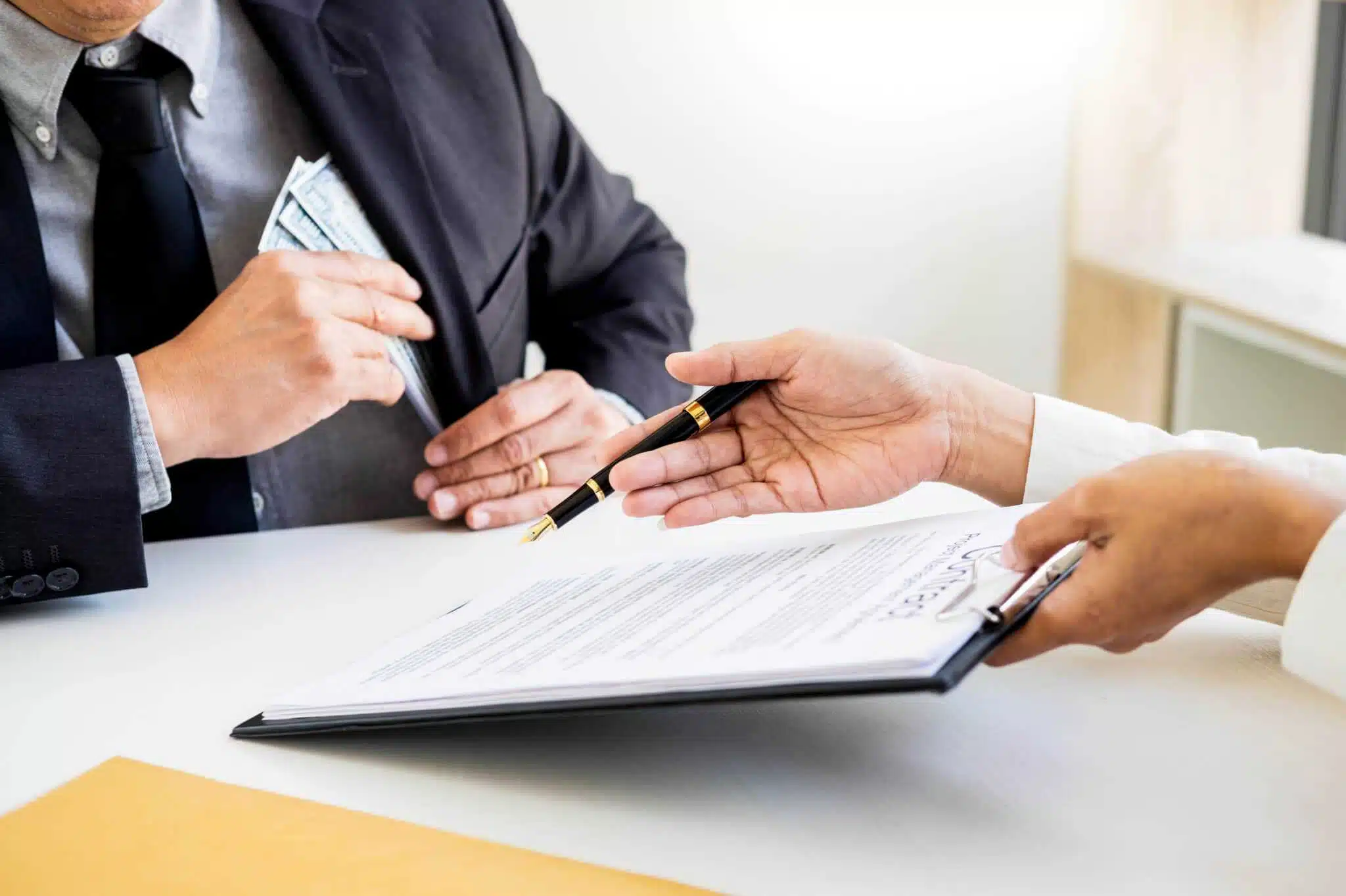 Two people signing a document at a desk in a tourist accommodation establishment in Teesdale, amidst the visitor surge.