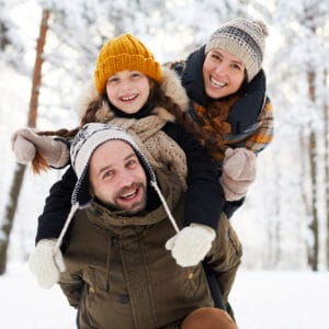 A family is having fun in the snow.