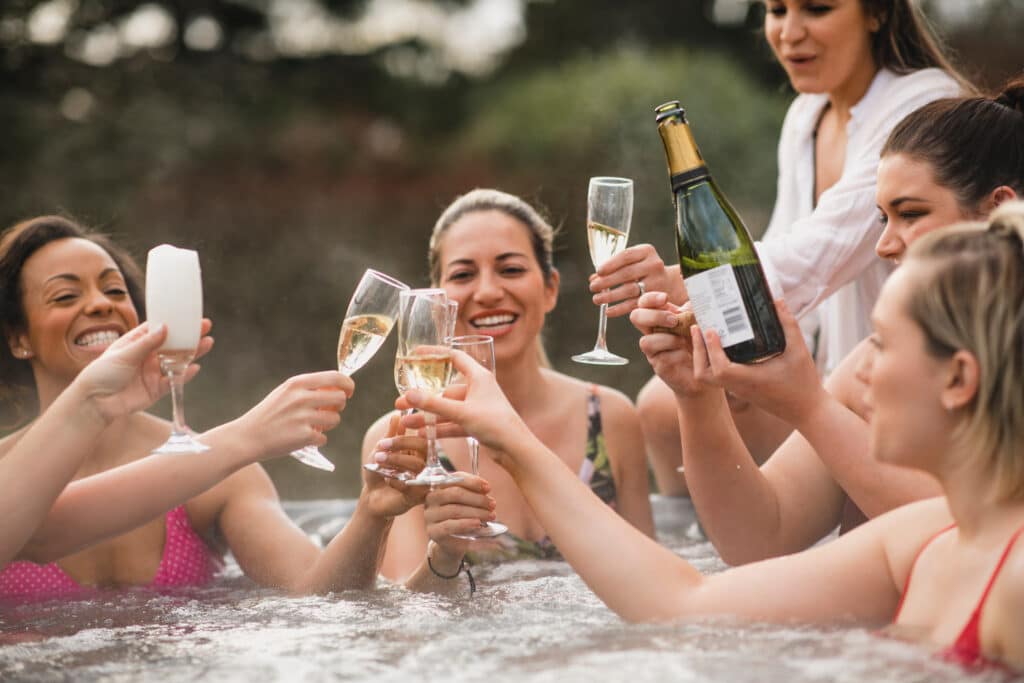 A group of women toasting champagne in a UK Glamping Pod.
