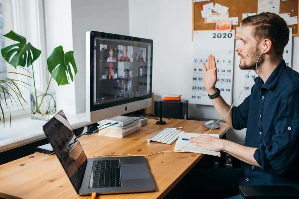 A man, representing Lazydays Holdings, is sitting at a desk with a laptop during the Q4 2021 Financial Results Conference Call.