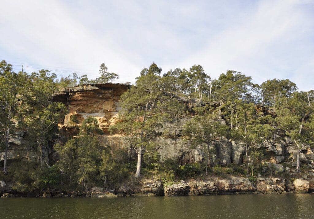 The Nowra Gateway Site, a former rock formation on the side of a body of water, has been transformed into a serene Short Stay Caravan Park.