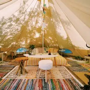 A room in a Utah glampground tent with a rug on the floor.