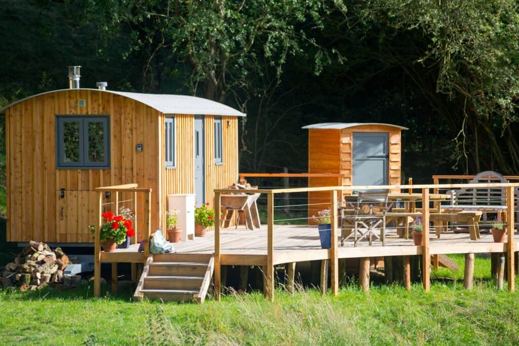 A rustic wooden cabin nestled on a charming wooden deck, honored as the winner of the Rural Business Awards 2021/2022.