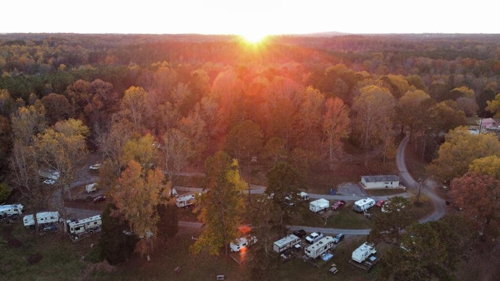 An aerial view of the Carolina Rose Campground, an rv park at sunset.