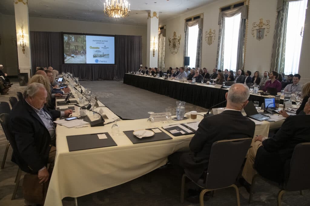 A group of people sitting around a table in a conference room discussing RVIA registration for RVs.