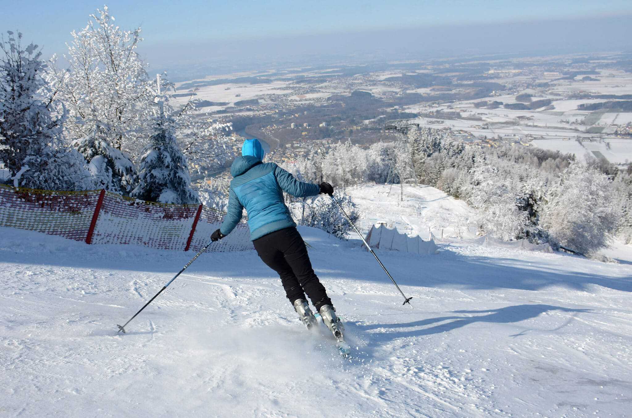 A person skiing down a snow covered slope in Maine, also known as Vacationland.