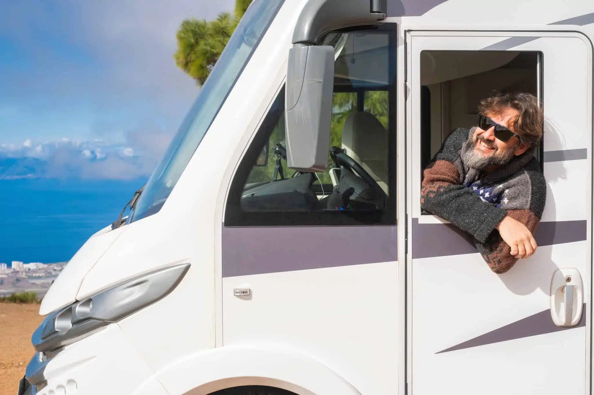 A man leaning out of the window of a caravan at the Outdoor Expo on the Gold Coast.