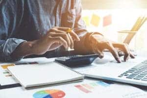 A developer revises plans for the proposed Preston RV Park while working on a laptop at a desk.