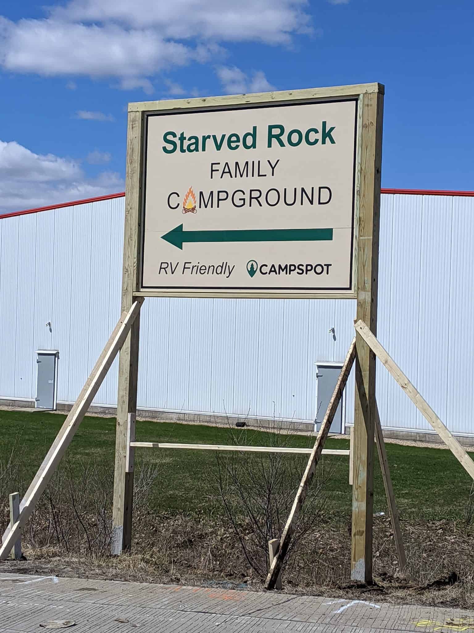 An "Opening Soon" sign for Starved Rock Family Campground in front of a building.