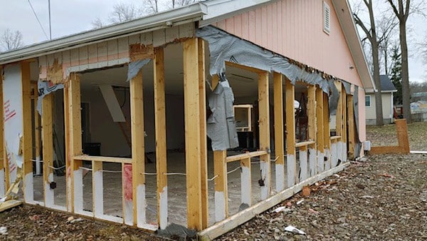 A house is being remodeled in a wooded area, seeking donations for the renovation project.