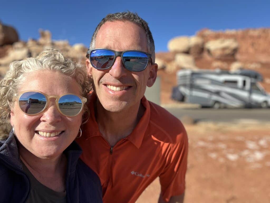 A couple embarking on an epic RV road trip across 14 states, capturing unforgettable moments with a selfie in front of their RV. #RVLove