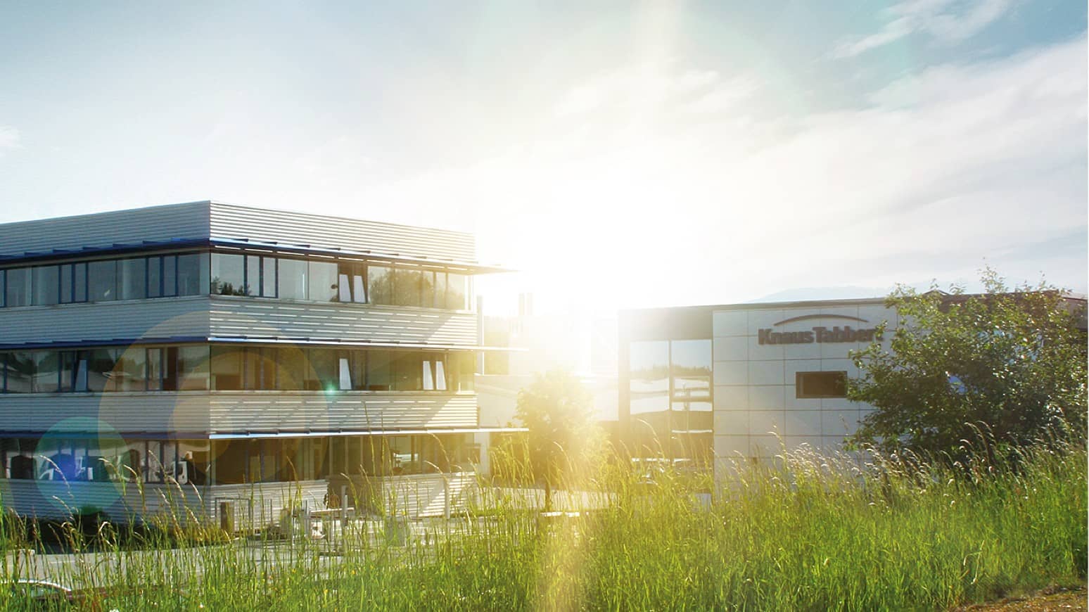 An office building with tall grass in the background, facing supply issues.