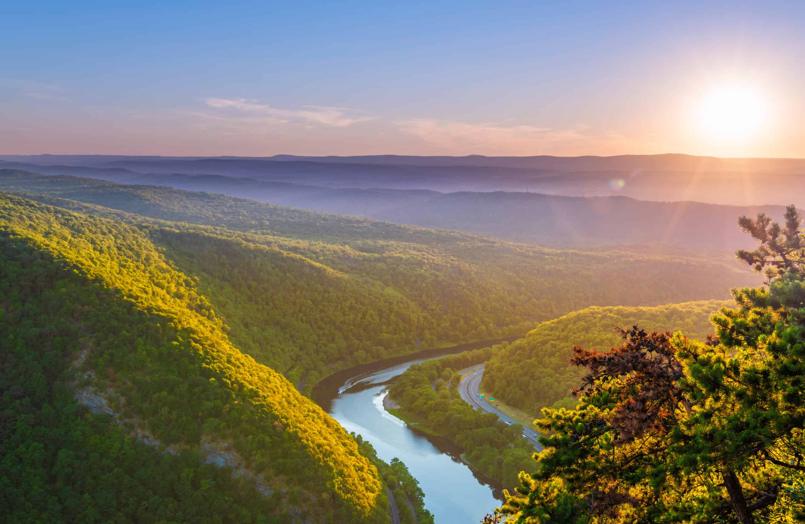 The sun rises over the Delaware Water Gap National Park in Warren County.