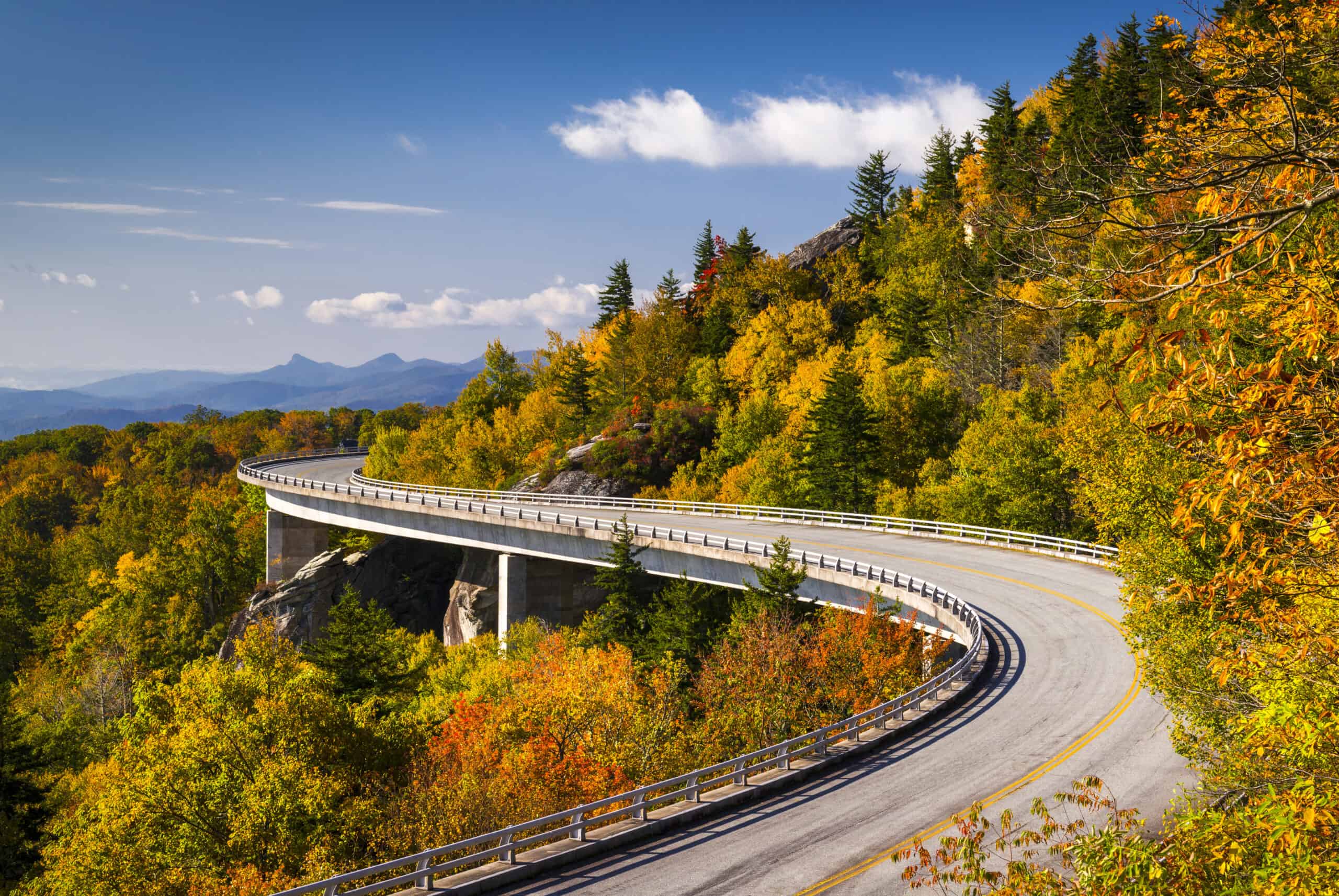 The Blue Ridge Parkway, funded by the Great American Outdoors Act with $127M, winds through the breathtaking Great Smoky Mountains.