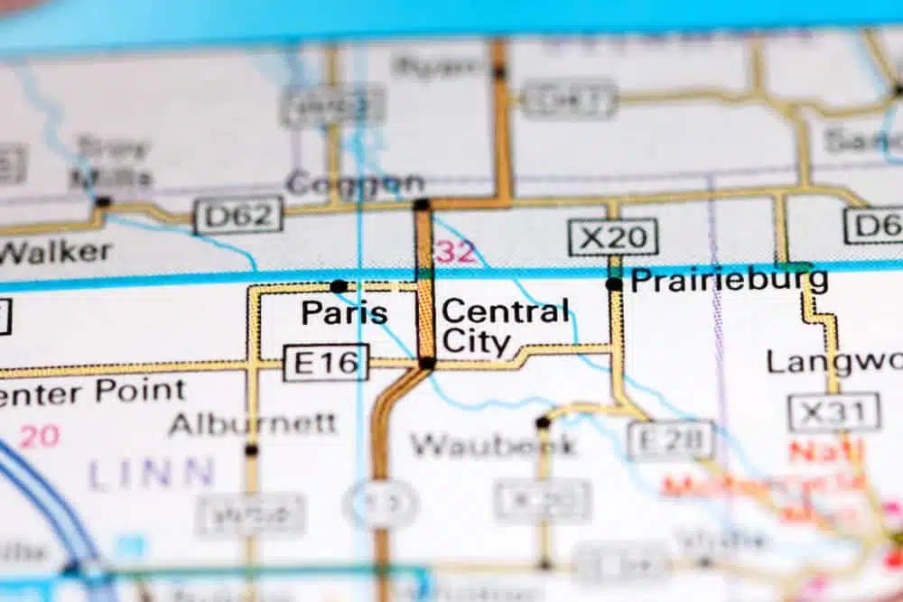 An Open hand is pointing at a map of Paris central city.