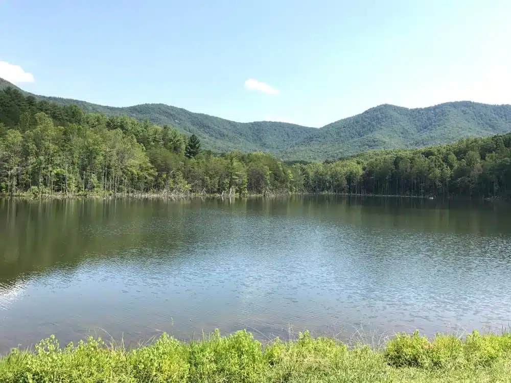 A proposed Glamping site in Burke County featuring a lake surrounded by trees and mountains.