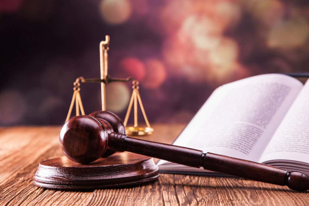 A judge's gavel resting upon an open book amidst the peaceful surroundings of a Maryland State Park.