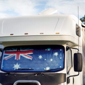 A white Victorian caravan with an Australian flag on it.