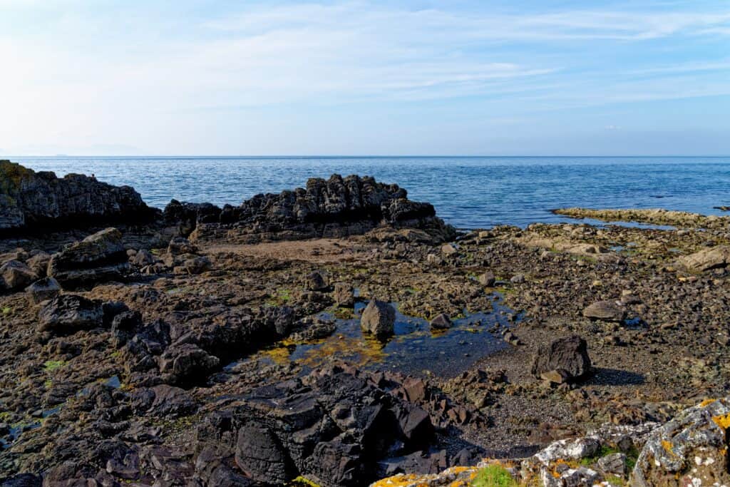 Parkdean Resorts invests in a rocky shore with a blue sky and a lot of rocks for their Caravan Holiday Park.