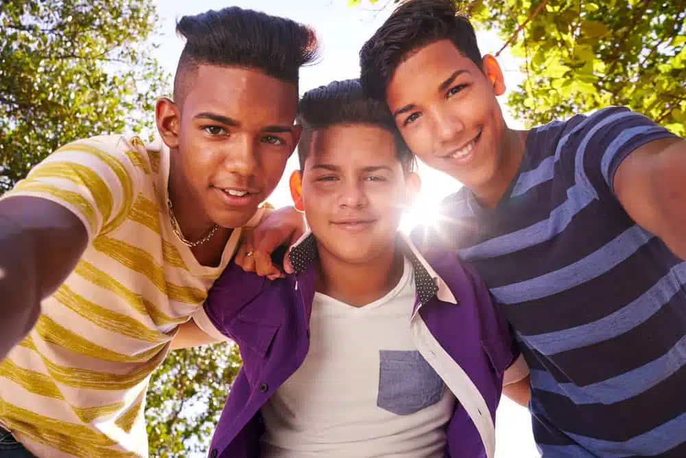 Three young men are taking a selfie in a Wyoming State Park.