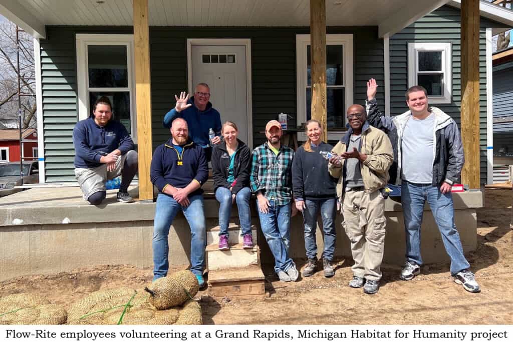 A team of Volunteer Team Members standing in front of a house.