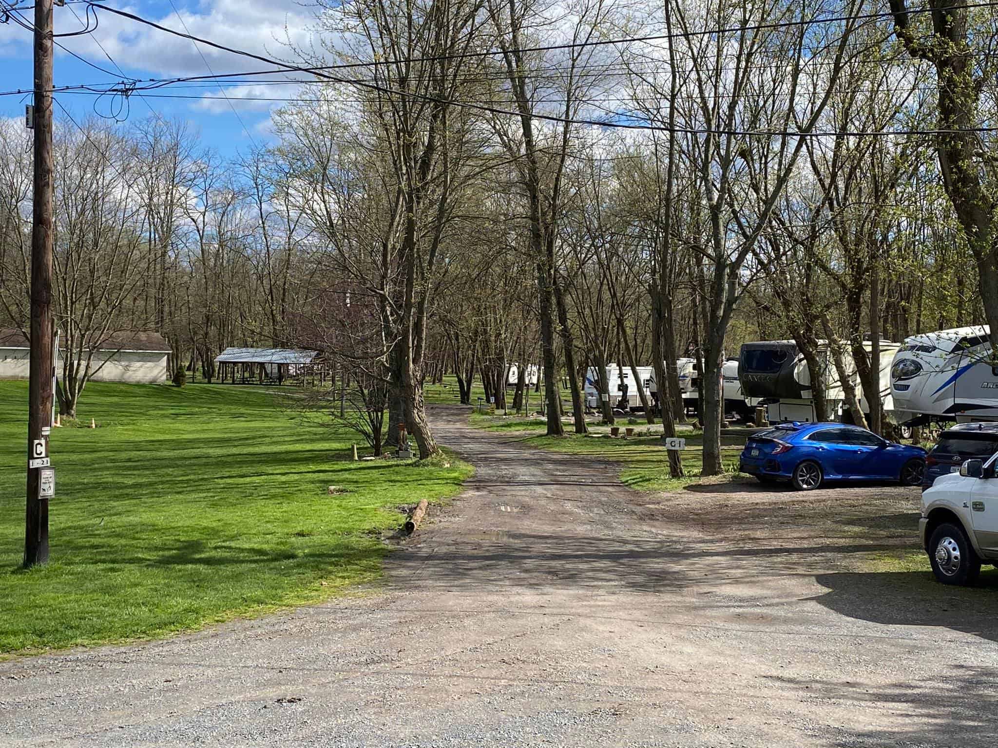 Indian Head Campground is a scenic RV park in Pennsylvania, nestled within a serene wooded area. Families can enjoy the tranquility of nature while parking their cars next to each other for convenience.