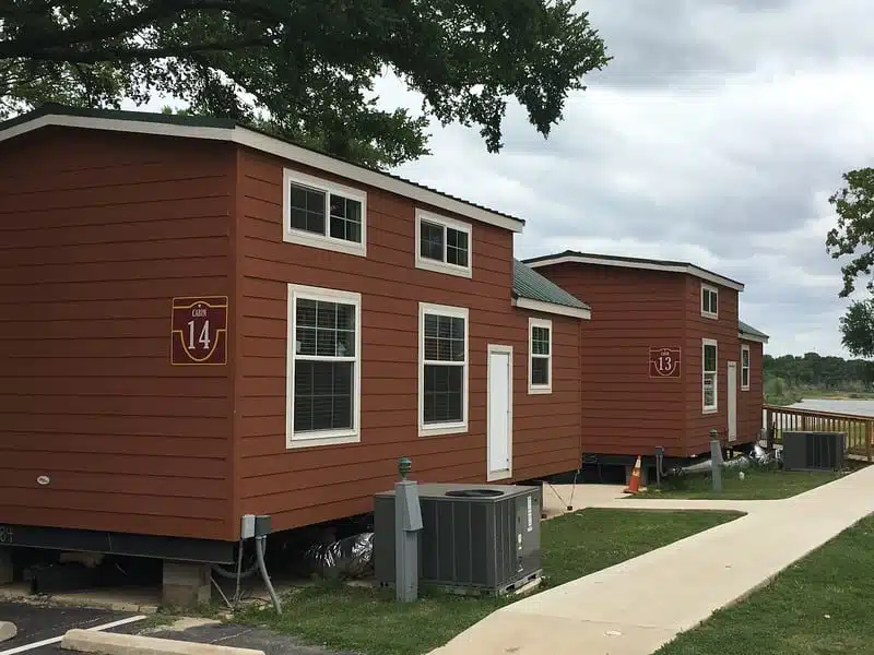 A row of cabins on the side of the road, perfect for Texas campsites during Fourth of July weekend.