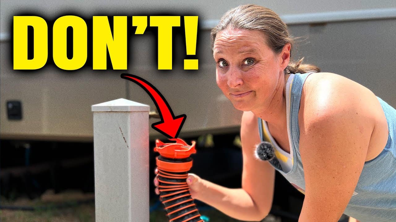 A woman is putting a hose on a pole next to an RV for RV camping.