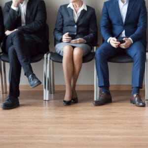 A group of employers sitting in a row, discussing job openings for the month of March.