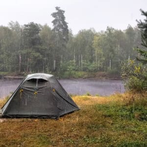 A tent is set up near a lake in the Manitoba Provincial Campgrounds, despite the wet weather.