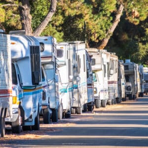 A row of RVs parked on the side of a road near General RV Center.
