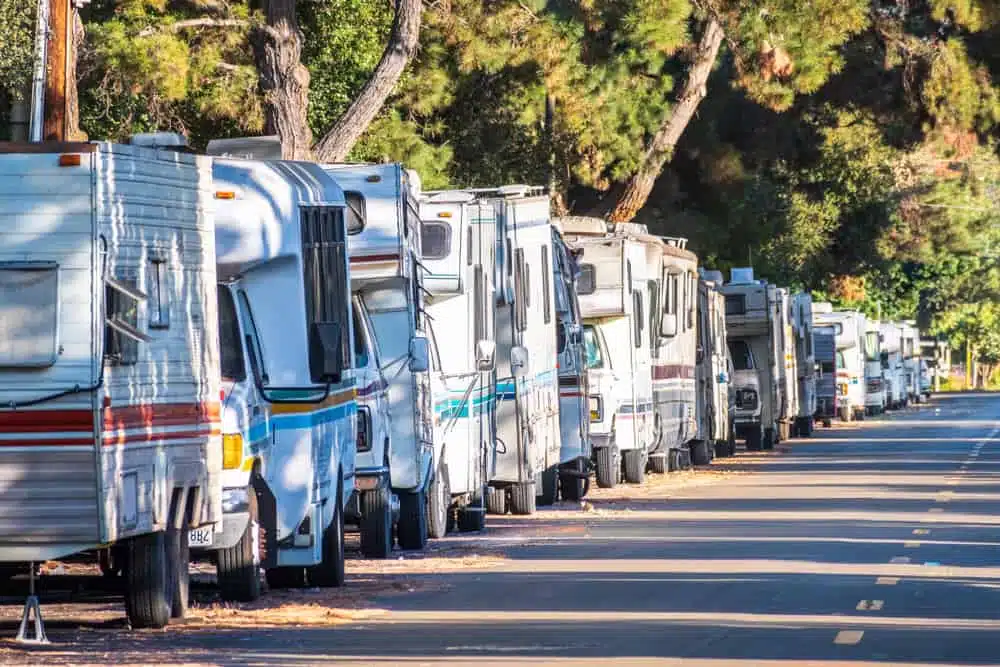 A row of RVs parked on the side of a road near General RV Center.