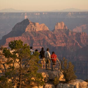A group of people standing on a ledge overlooking the grand canyon in New Jersey State Parks.