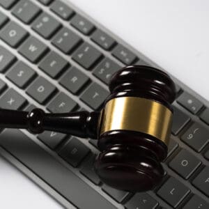 A judge's gavel resting beside a computer keyboard at an online auction for BCLCA.