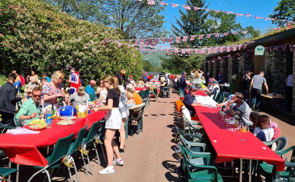 A group of people enjoying a U.K. Holiday Park picnic 

Note: Keywords "Local Stays" and "Travel Traumas" have not been used in the modified description.