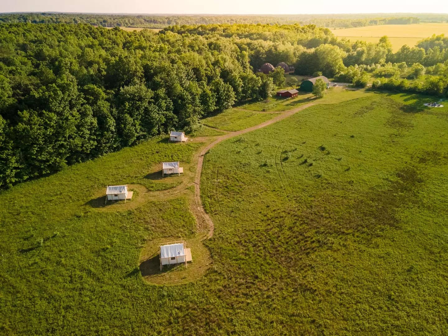 An aerial view of a glampground in Michigan, featuring a group of tents.