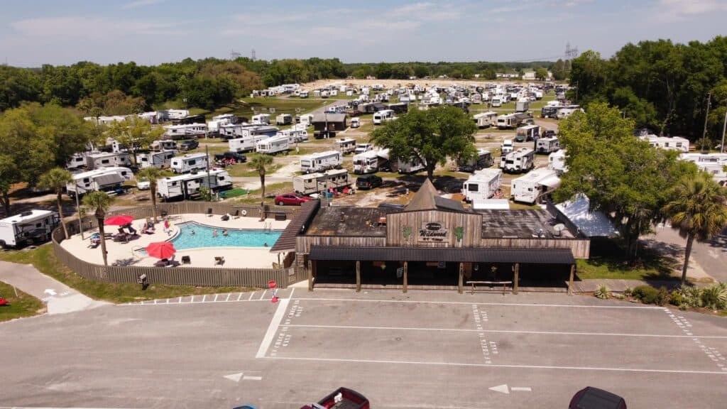 An aerial view of Wildwood RV Village, a sprawling rv park with lots of parked rvs.