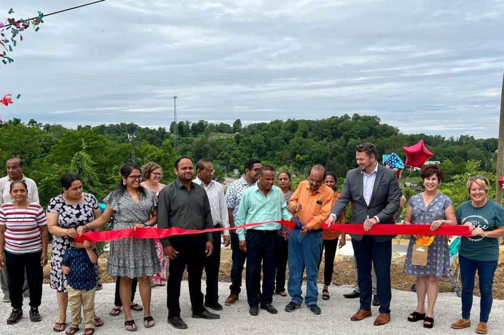 The Marion County Chamber of Commerce gathers at the Fairmont Hills RV Park to cut a ribbon during a ribbon cutting ceremony.