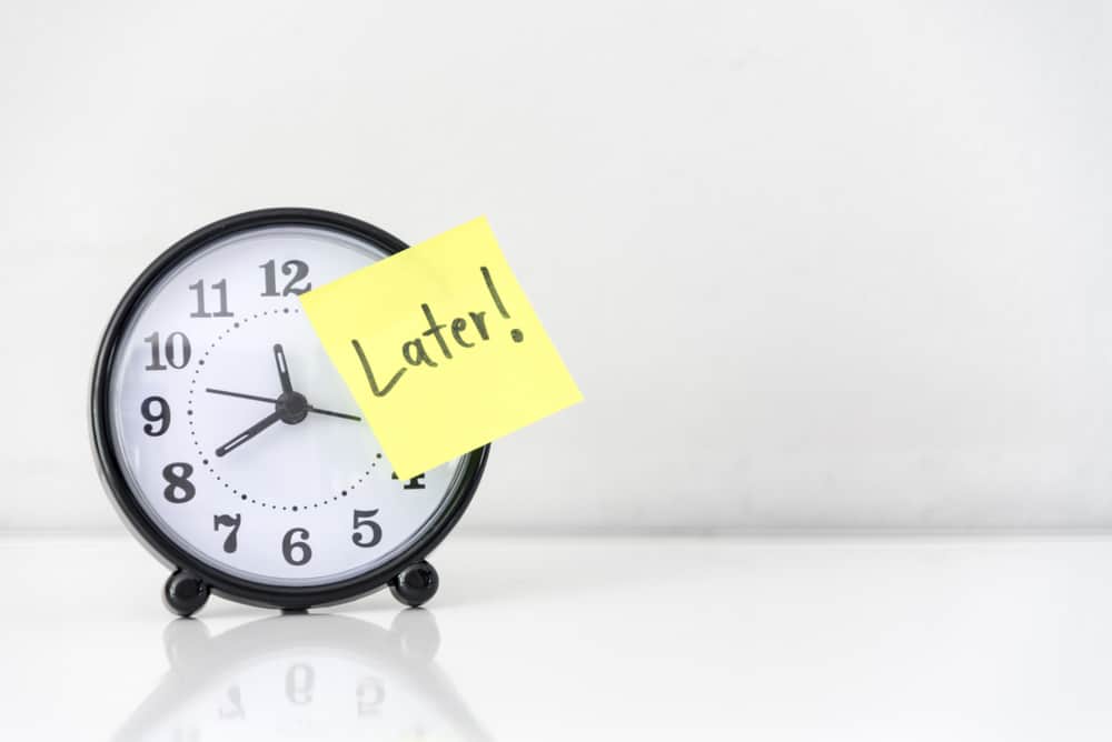 A clock with a yellow sticky note on it - late council stock videos & royalty-free footage.