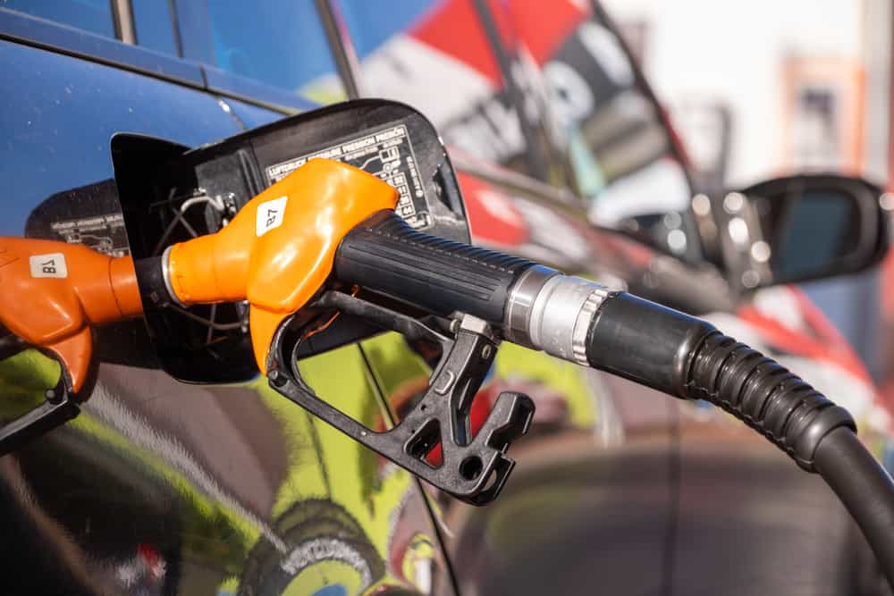 A car is being fueled up at a gas station as gas prices drop slightly.