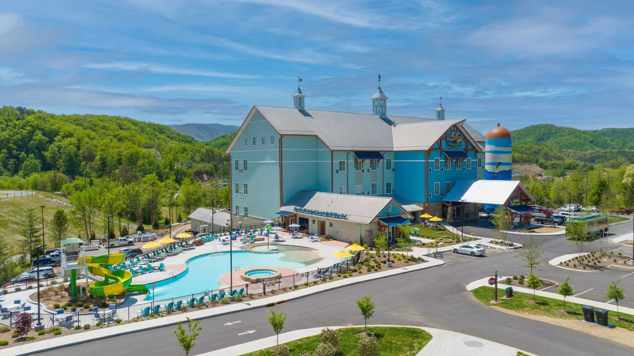 An aerial view of a resort with a pool and water slide.