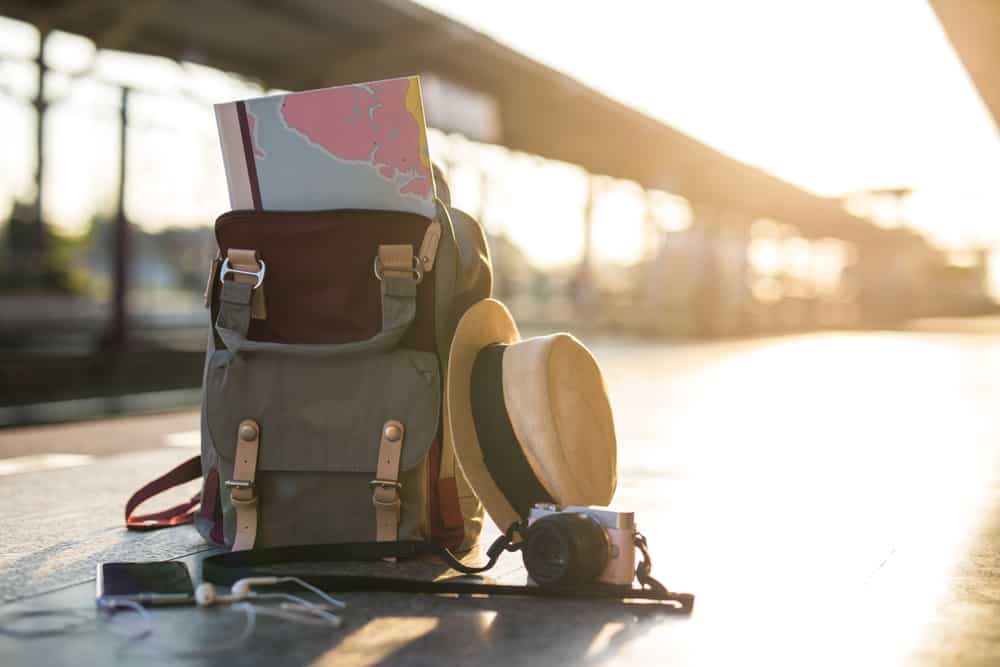 A backpack and hat on a Mont-Saint-Grégoire train platform, representing adventure tourism.