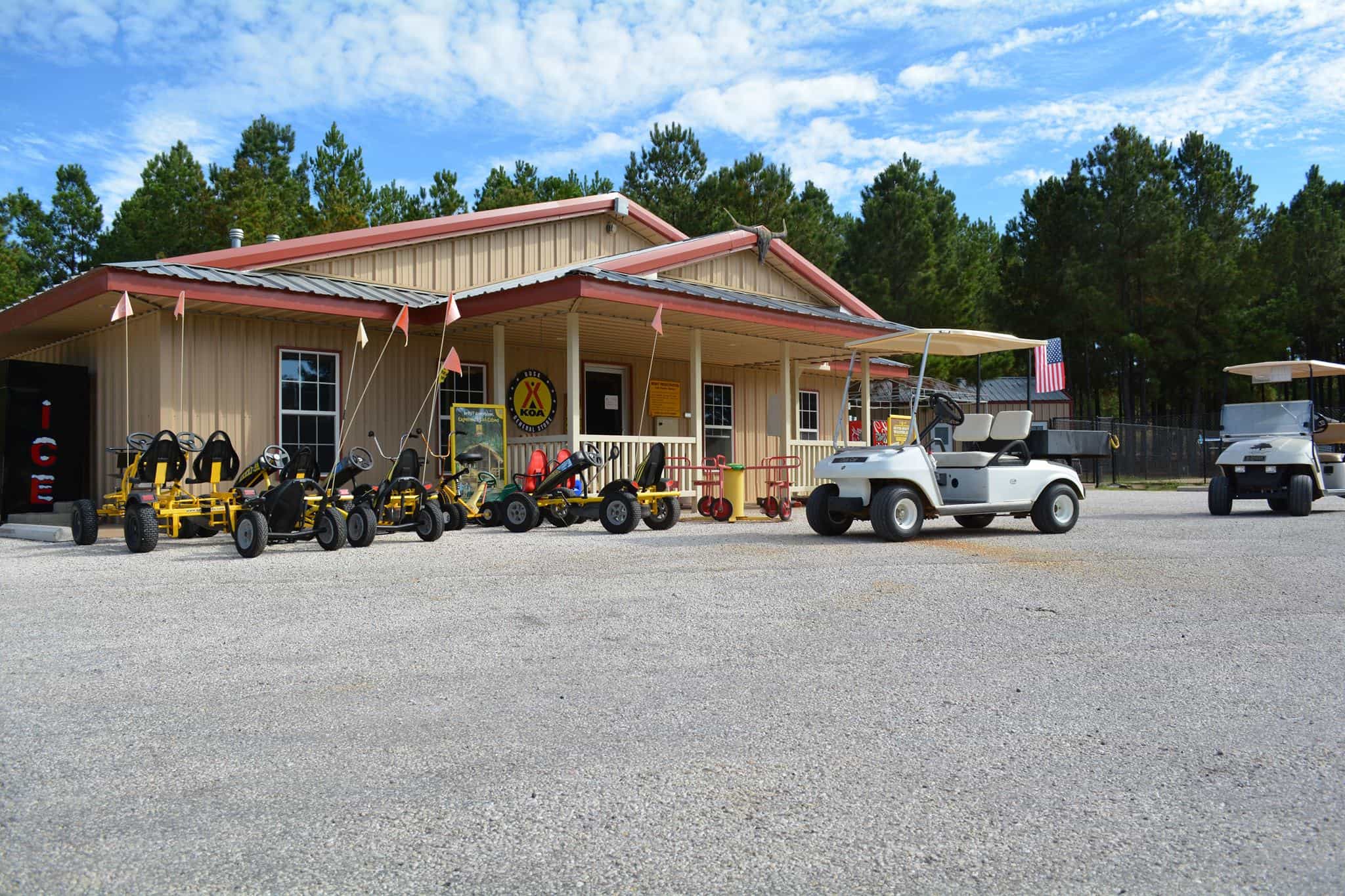 Golf carts parked in front of the Rusk KOA Holiday.