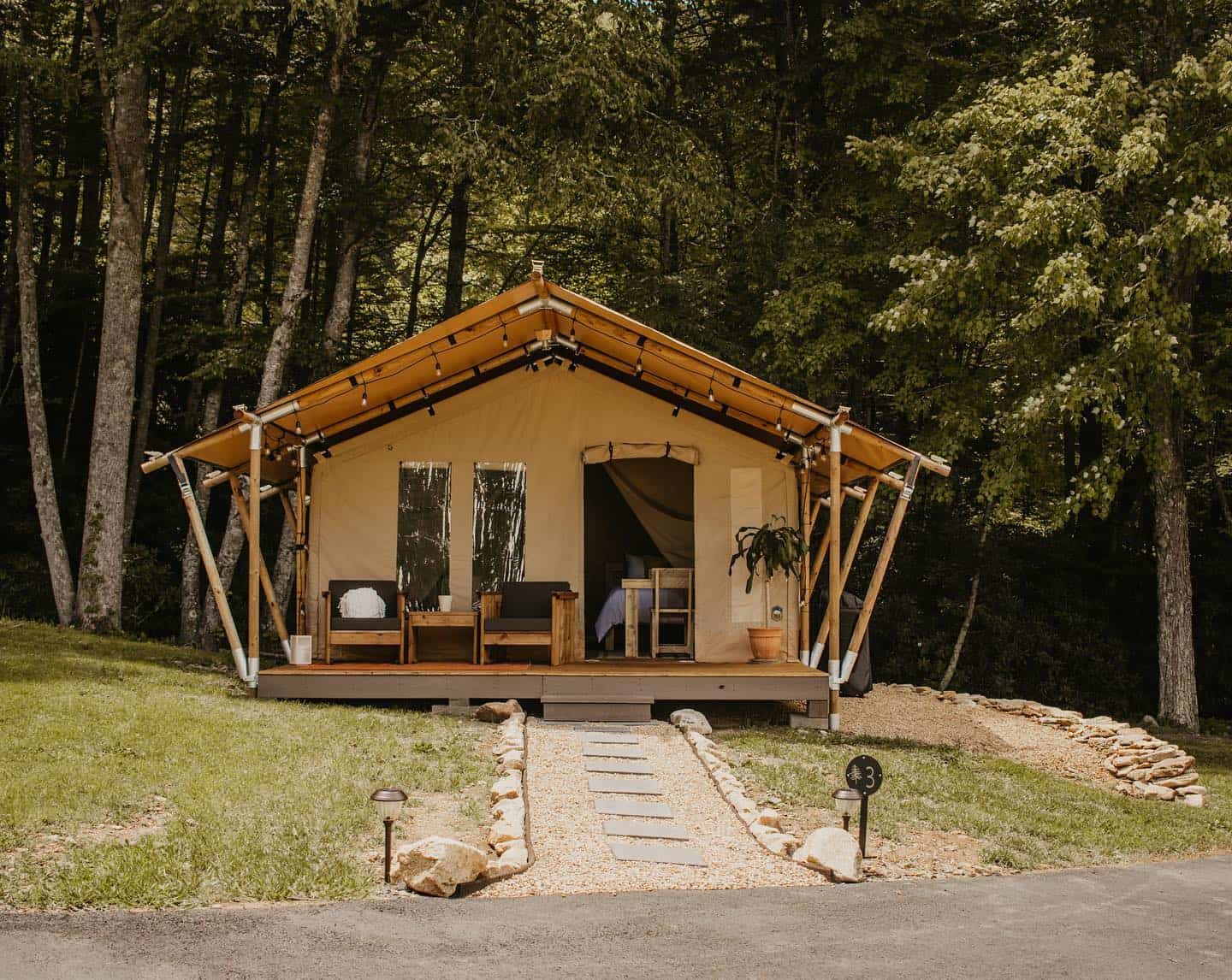 A glamping getaway in Unicoi County nestled next to a tree in the woods.