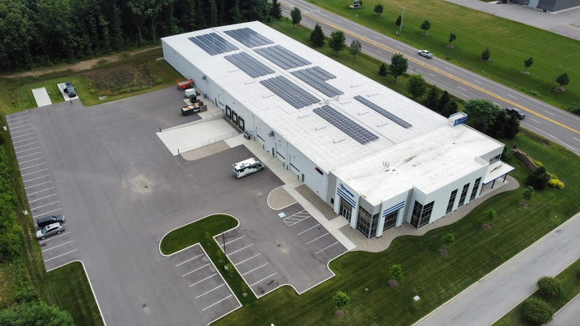 An aerial view of a building in Elkhart with solar panels on the roof.