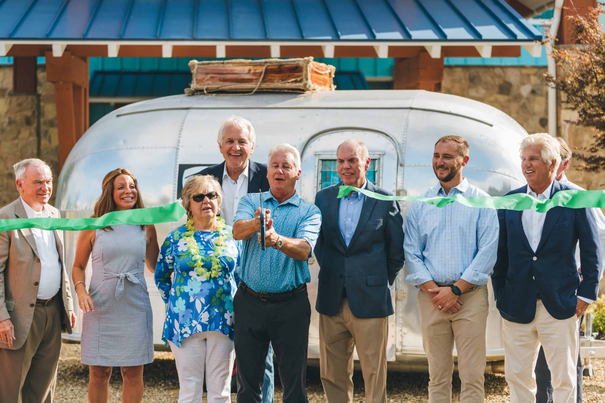 A group of people standing in front of an airstream trailer at Camp Margaritaville.