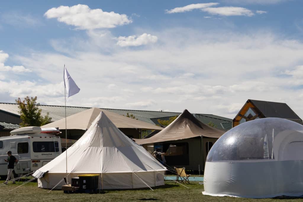 The Colorado Glamping Show USA kicks off with a group of tents set up on a lush grassy field.