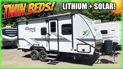 A picture of a Winnebago Micro Minnie camper with two beds and a solar panel.